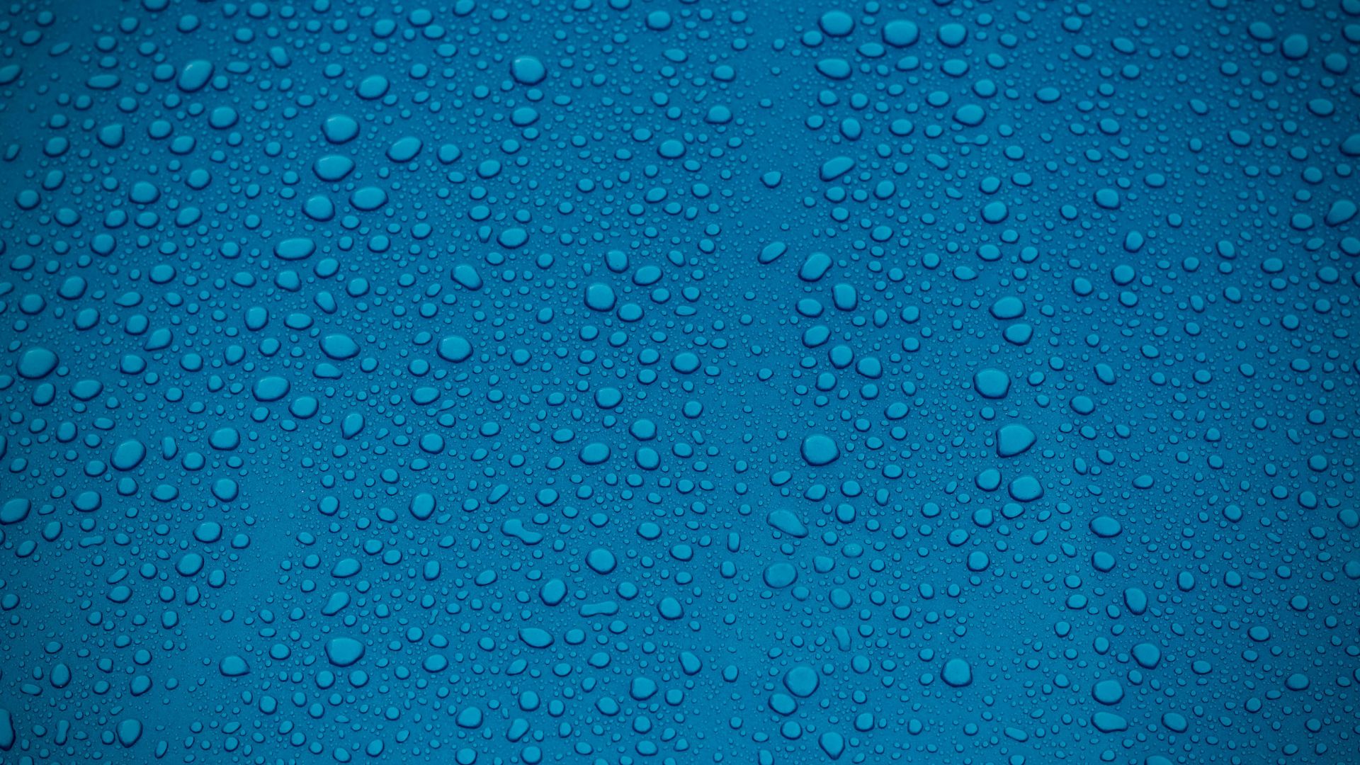 clear water drops on blue background