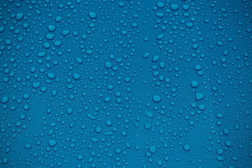 clear water drops on blue background