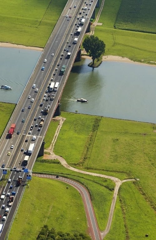 Road with traffic in a landscape with water